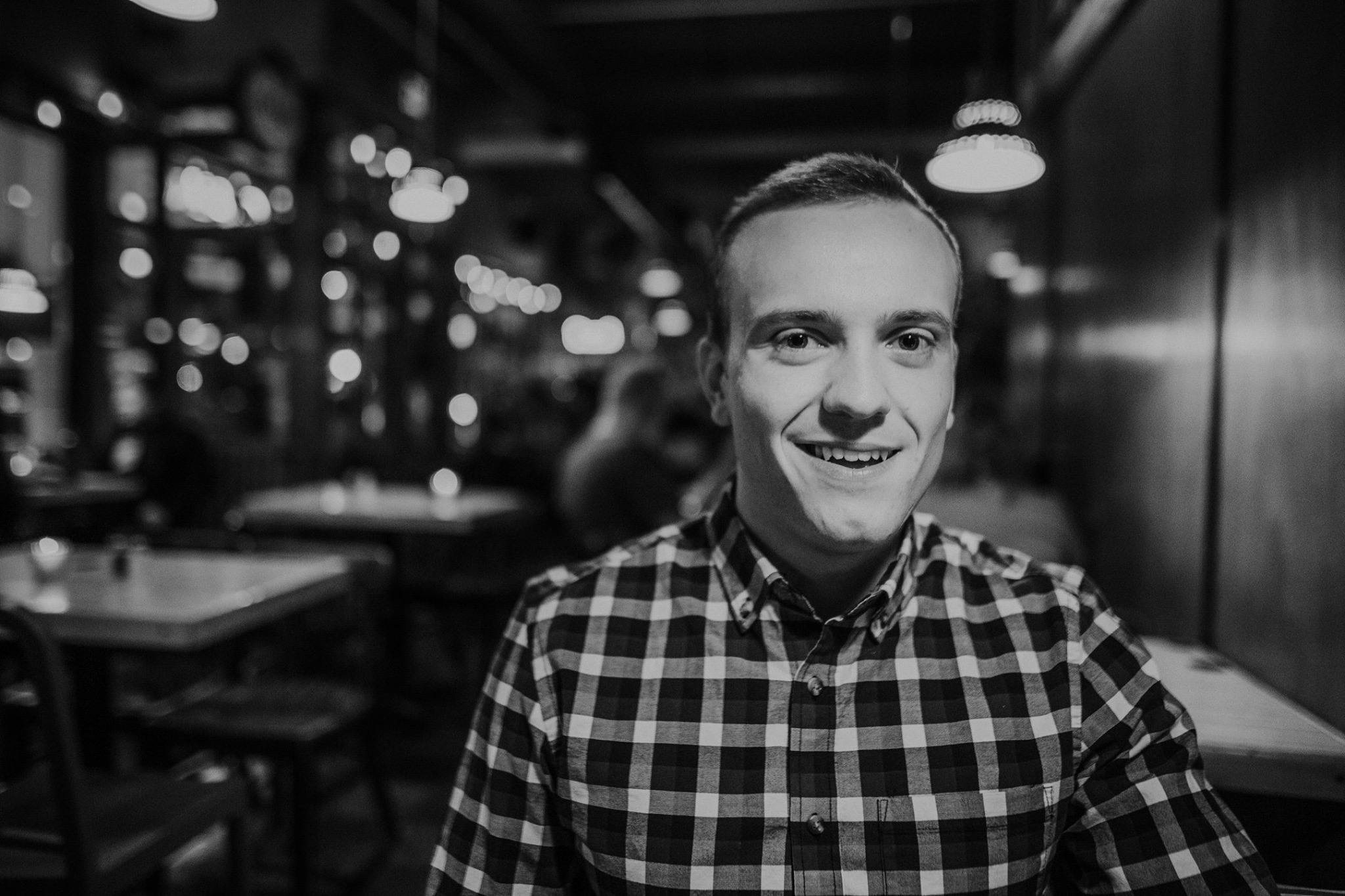 Man in striped collared shirt smiling