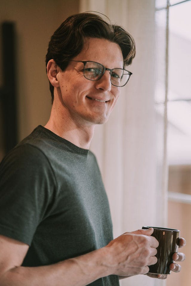 Dating profile photo with coffee, taken by The Match Artist