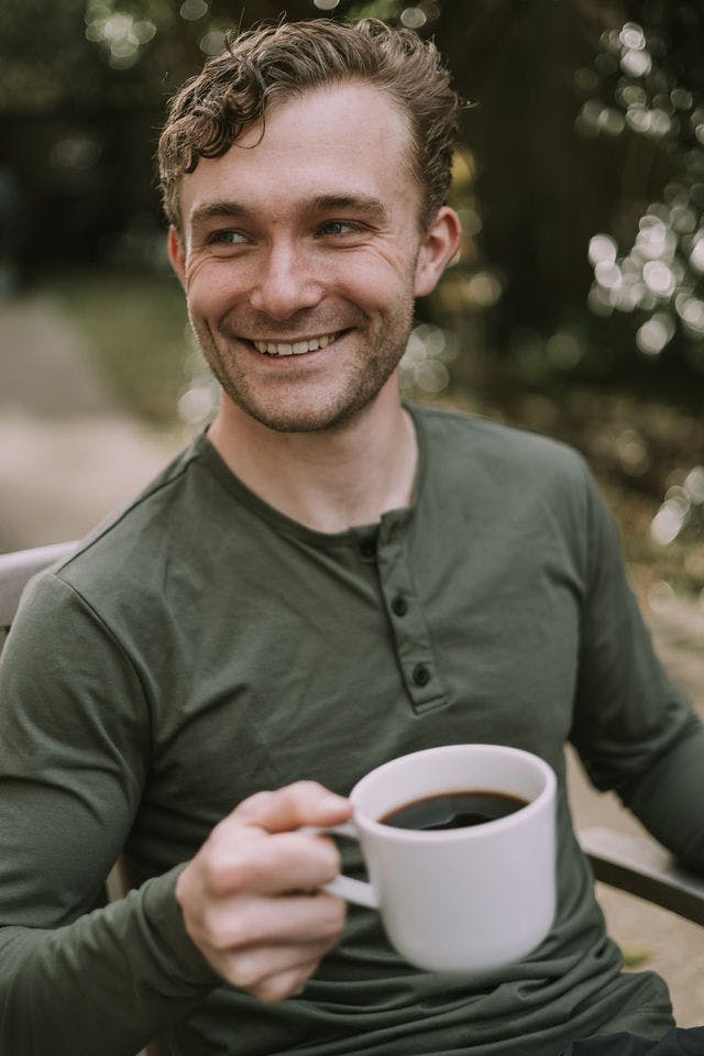 Dating profile photo with coffee, taken by The Match Artist