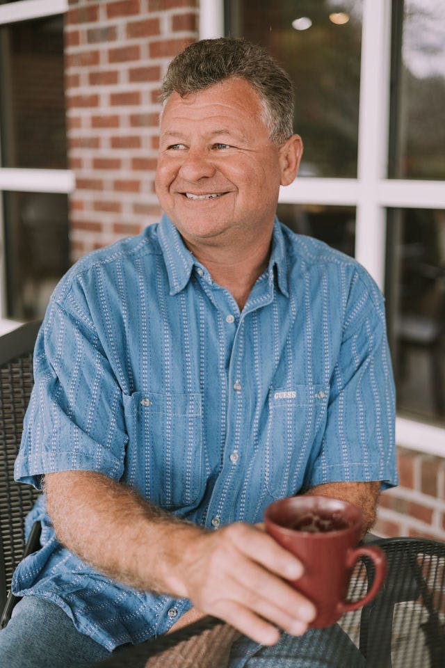 Dating profile photo with coffee, taken by The Match Artist