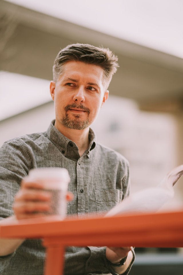 Dating profile photo with coffee, taken by The Match Artist