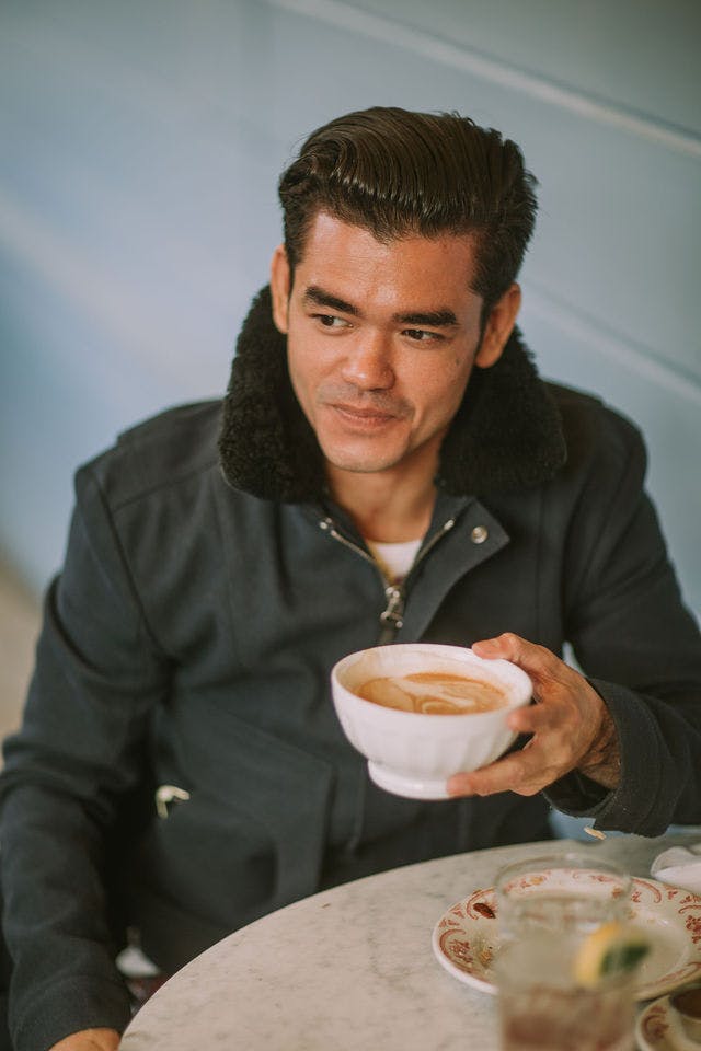 Dating profile photo with coffee, taken by The Match Artist