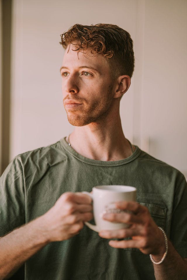 Dating profile photo with coffee, taken by The Match Artist