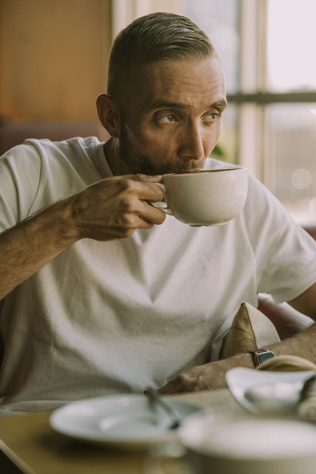 Dating profile photo with coffee, taken by The Match Artist