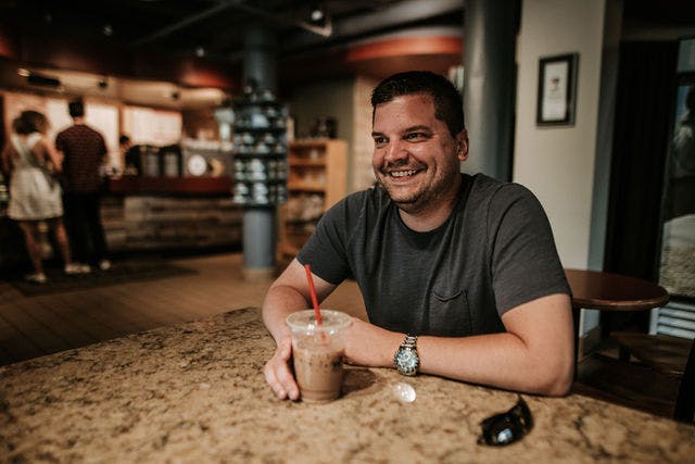 Dating profile photo with coffee, taken by The Match Artist