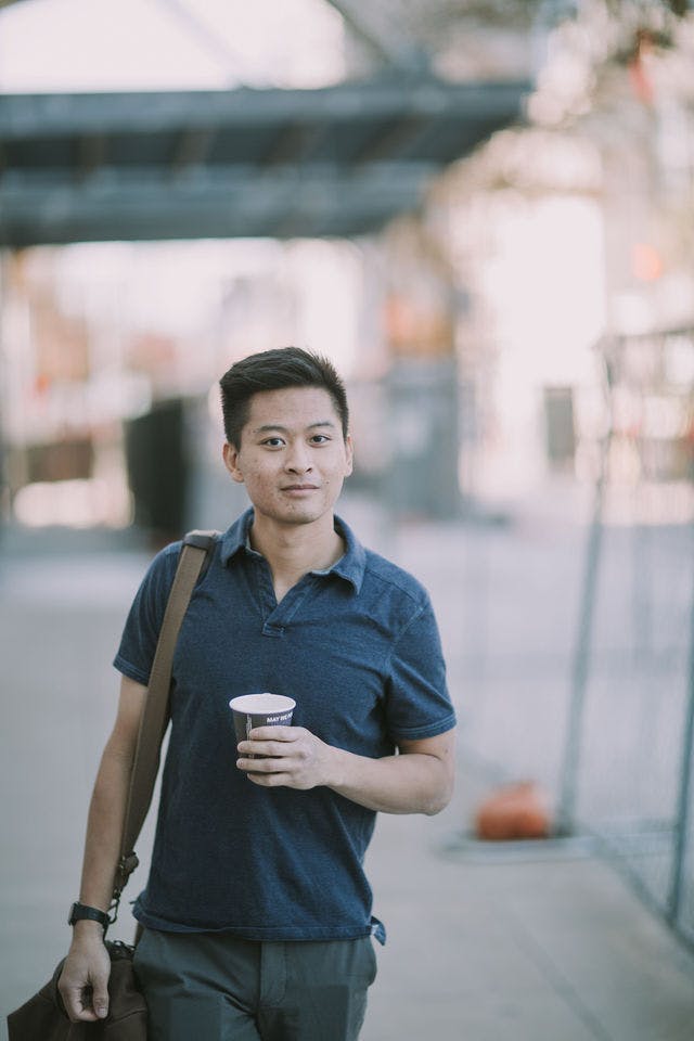 Dating profile photo with coffee, taken by The Match Artist