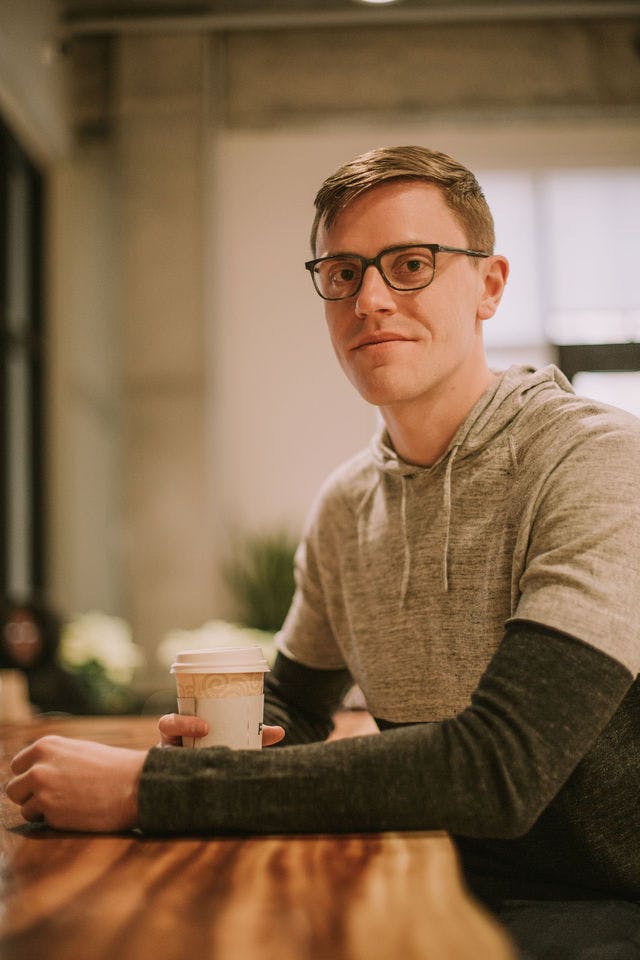 Dating profile photo with coffee, taken by The Match Artist