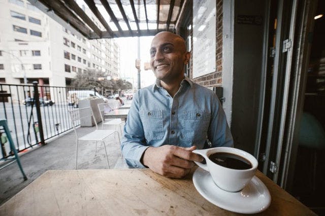 Dating profile photo with coffee, taken by The Match Artist