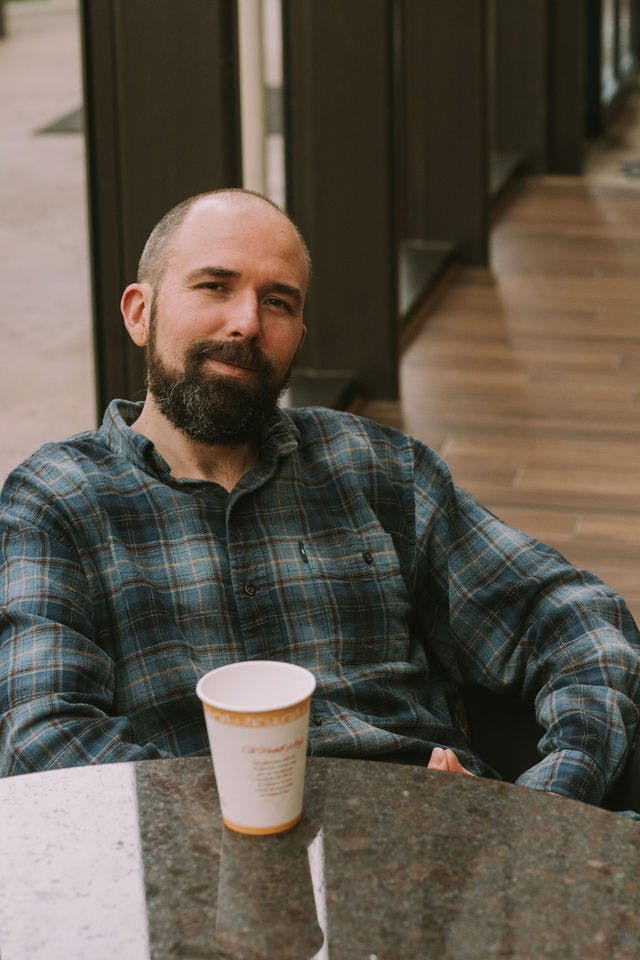 Dating profile photo with coffee, taken by The Match Artist