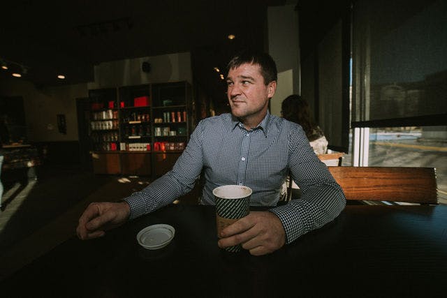 Dating profile photo with coffee, taken by The Match Artist