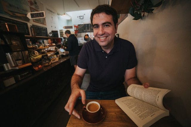 Dating profile photo with coffee, taken by The Match Artist