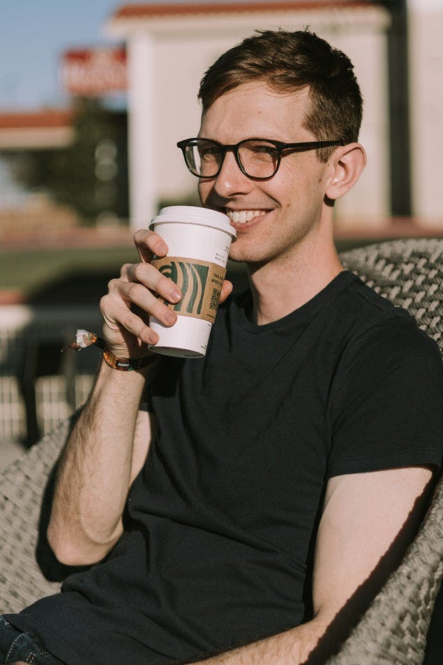 Dating profile photo with coffee, taken by The Match Artist