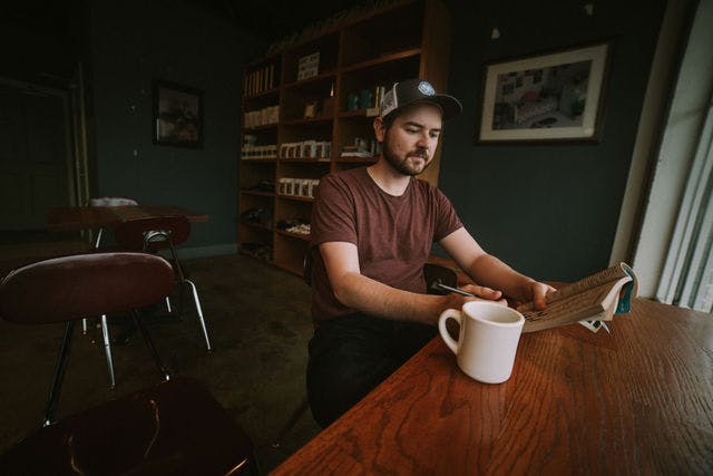 Dating profile photo with coffee, taken by The Match Artist