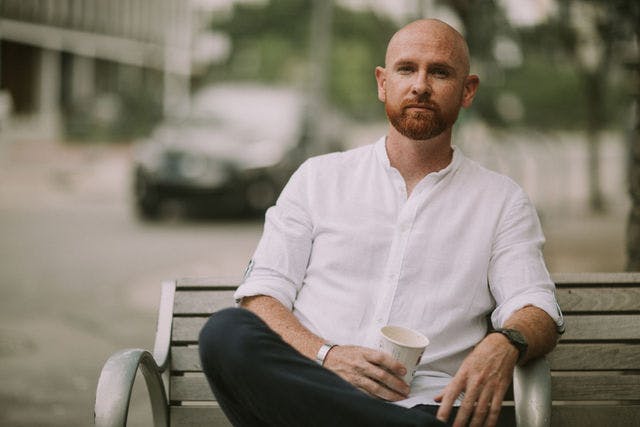 Dating profile photo with coffee, taken by The Match Artist