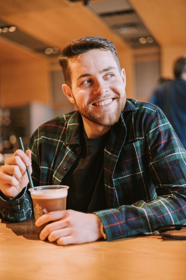 Dating profile photo with coffee, taken by The Match Artist