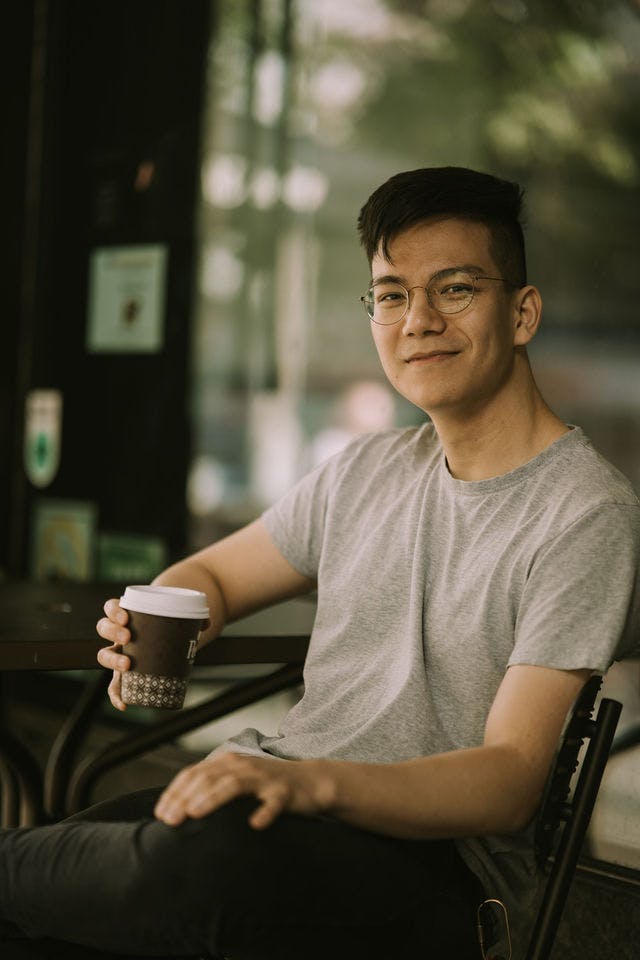 Dating profile photo with coffee, taken by The Match Artist