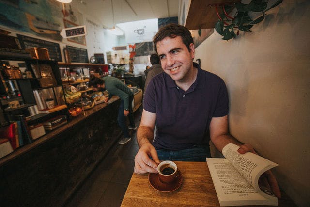 Dating profile photo with coffee, taken by The Match Artist