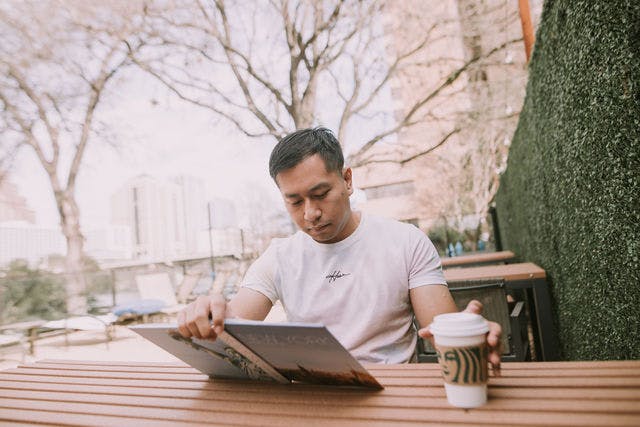 Dating profile photo with coffee, taken by The Match Artist