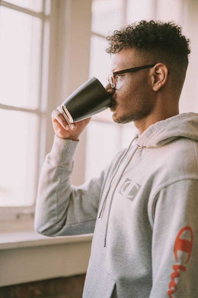 Dating profile photo with coffee, taken by The Match Artist