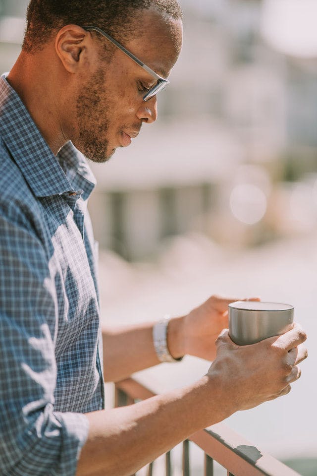 Dating profile photo with coffee, taken by The Match Artist