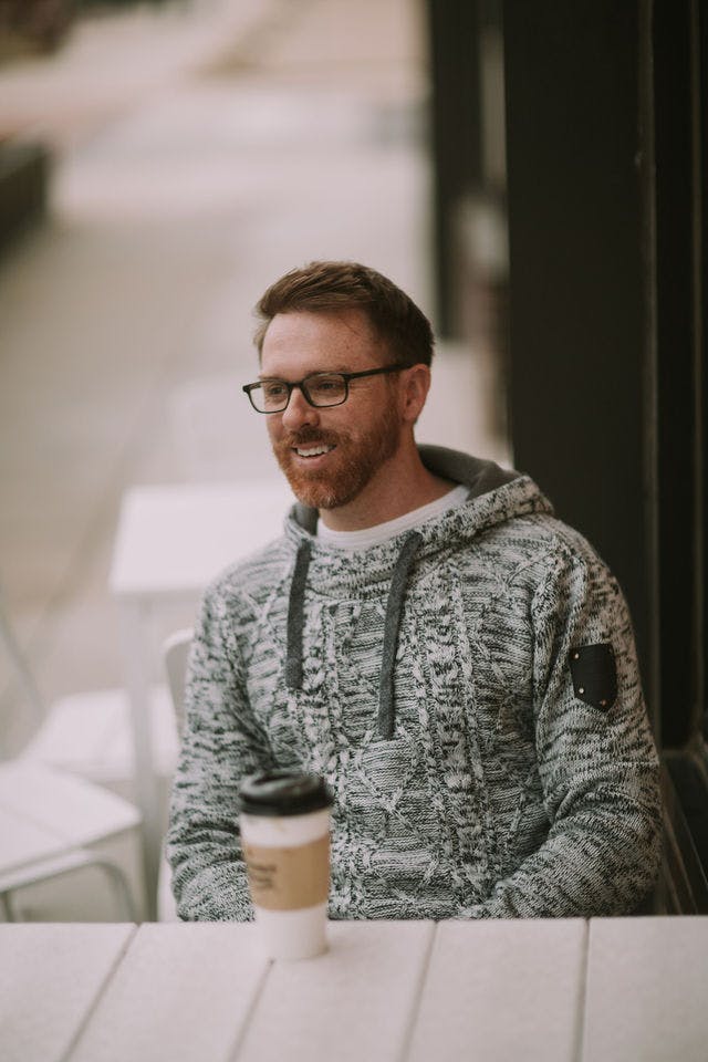 Dating profile photo with coffee, taken by The Match Artist