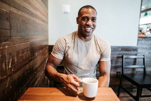 Dating profile photo with coffee, taken by The Match Artist