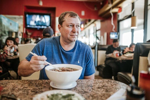 Dating profile photo with coffee, taken by The Match Artist