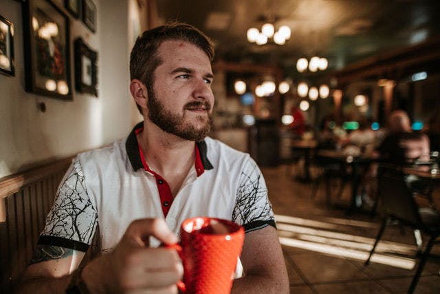 Dating profile photo with coffee, taken by The Match Artist