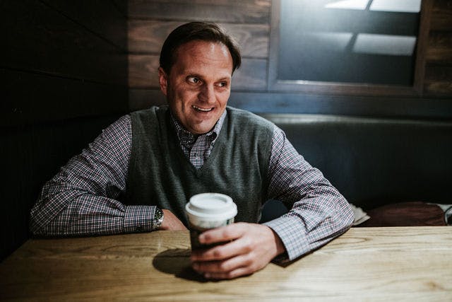 Dating profile photo with coffee, taken by The Match Artist