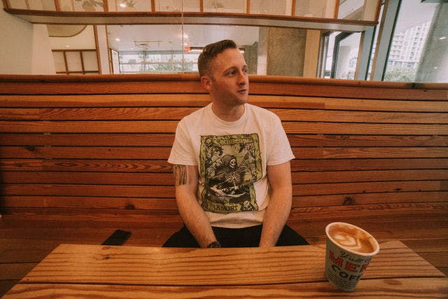 Dating profile photo with coffee, taken by The Match Artist